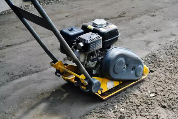 Plate compactor on granular soil