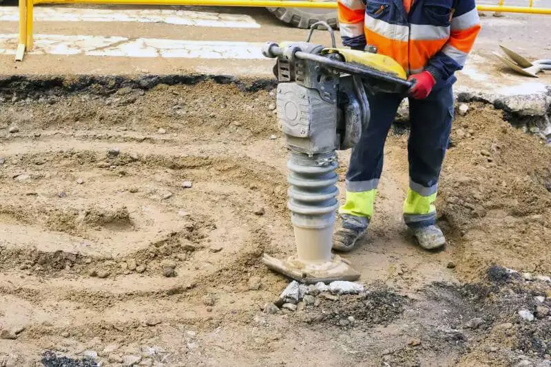 Rammer being used on clay